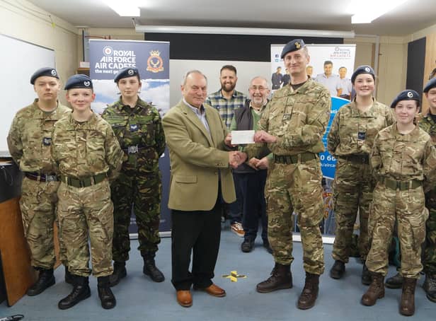 Keith Musson made the presentation to Flt Lt Marcus Hyde, watched by fellow Freemasons  and some of the cadets EMN-220329-090707001