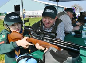 Kids Country Cubs and Scouts event at the East of England Arena. Instructor Ian Richardson with Joshua Perkins learning how to use and air rifle. EMN-220328-140200009