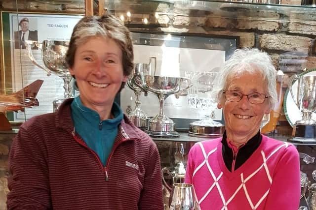 Pictured is past Captain Ruth Simpson presenting the Cheer Cup to Val Simpson (right).