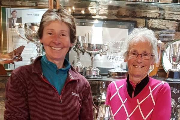 Pictured is past Captain Ruth Simpson presenting the Cheer Cup to Val Simpson (right).