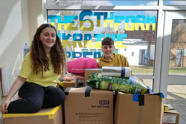 Logan Redford and Bethan Simpson packing boxes of donations.