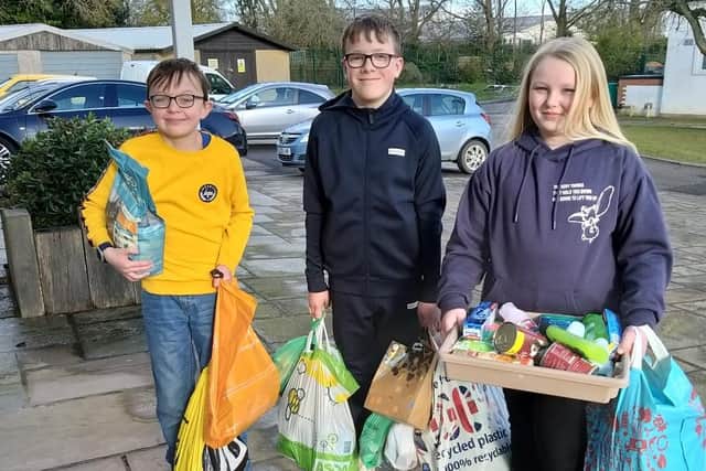 Lower school pupils with their donations.