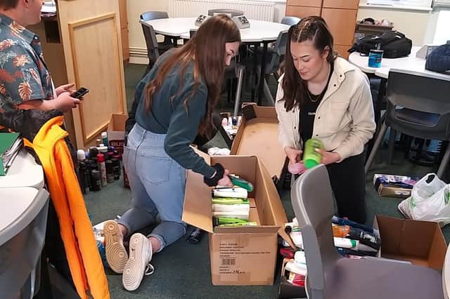 Year 13 students sorting boxes of donations.