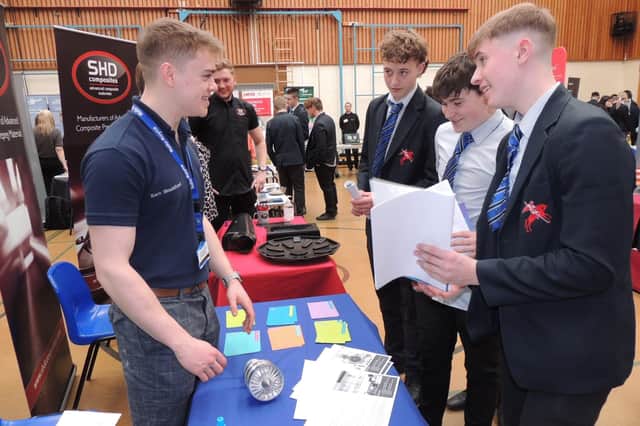 Former Carre's pupil Sam Mountford talking to students on the Rolls Royce stand at the careers fair. EMN-220104-172515001