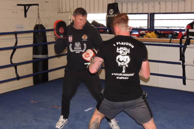 Amir Unsworth putting a boxer through his paces on the pads at his academy in Sleaford. EMN-220104-174129001