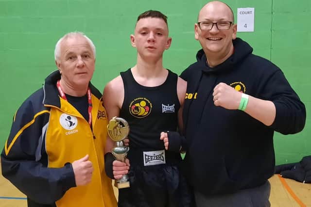 kai Merrion, flanked by coaches Kevin Smith and Scott Harmon.