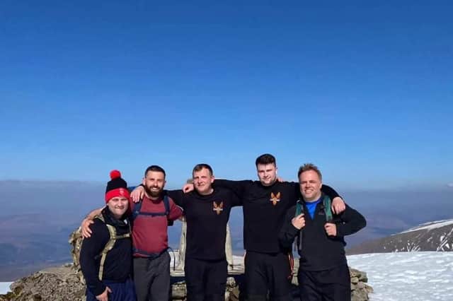 On top of the world! Members of the Brotherhood Project on the summit of Ben Nevis.