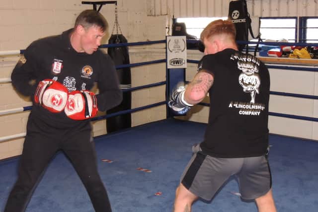 Amir Unsworth doing some pad work with an up and coming boxer. EMN-220804-184946001