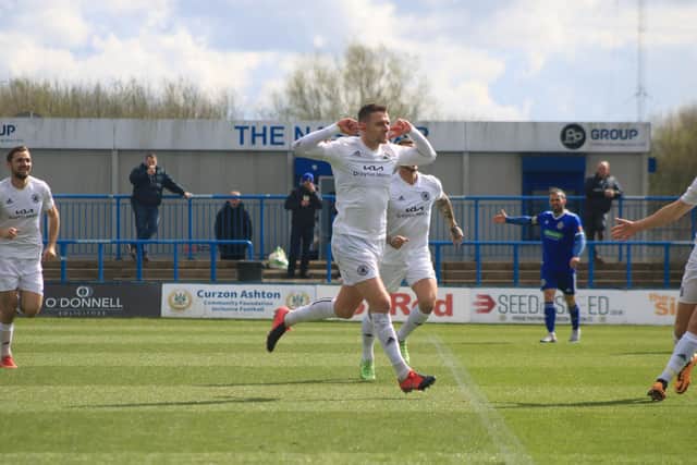 Joe Leesley celebrates his goal with a pointed message. Photo: Oliver Atkin