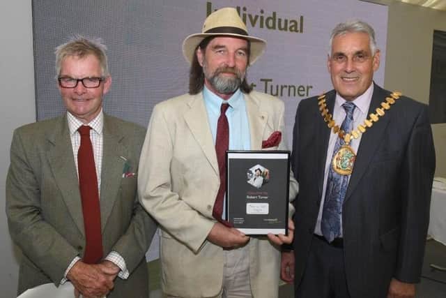 Leader of LCC Martin Hill (left) and chairman of LCC Tony Bridges (right) present the 2019 Citizen of the Year award to Robert Turner, of Caistor, a Lions Club member for more than 30 years.
