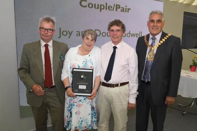 Leader of LCC Martin Hill (left) and chairman of LCC Tony Bridges (right). present the 2019 Couple of the Year award to Joy and Doug Rodwell, of Hemingby, described as good neighbours to those in need, who offer long-term support to any with serious illnesses..