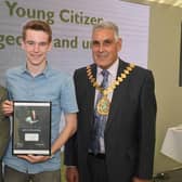 Leader of LCC Martin Hill (left) and chairman of LCC Tony Bridges (right) present the 2019 Young Citizen of the Year award for the work he did helping the community in the Wainfleet floods to Jack Covill-Lowndes of Wainfleet.