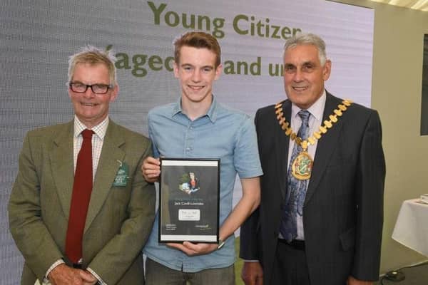 Leader of LCC Martin Hill (left) and chairman of LCC Tony Bridges (right) present the 2019 Young Citizen of the Year award for the work he did helping the community in the Wainfleet floods to Jack Covill-Lowndes of Wainfleet.
