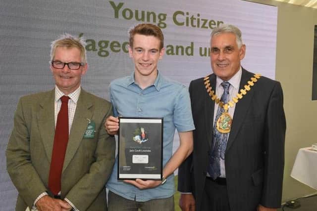 Leader of LCC Martin Hill (left) and chairman of LCC Tony Bridges (right) present the 2019 Young Citizen of the Year award for the work he did helping the community in the Wainfleet floods to Jack Covill-Lowndes of Wainfleet.