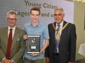 Leader of LCC Martin Hill (left) and chairman of LCC Tony Bridges (right) present the 2019 Young Citizen of the Year award for the work he did helping the community in the Wainfleet floods to Jack Covill-Lowndes of Wainfleet.