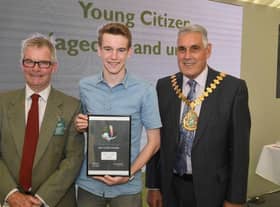 Leader of LCC Martin Hill (left) and chairman of LCC Tony Bridges (right) present the 2019 Young Citizen of the Year award for the work he did helping the community in the Wainfleet floods to Jack Covill-Lowndes of Wainfleet.