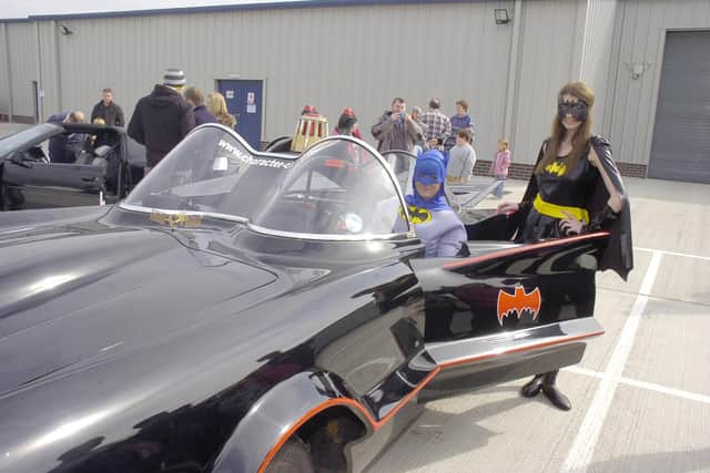 Batman and Batgirl with the Batmobile at Sleaford's AW Repair Group's charity fundraiser.