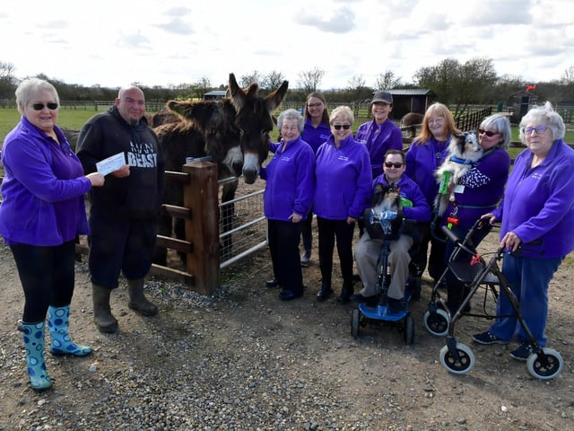 Members of the 50+ Fitness group from Mablethorpe present a cheque to Radcliffe Donkey Sanctuary volunteer Ross Ckarke.