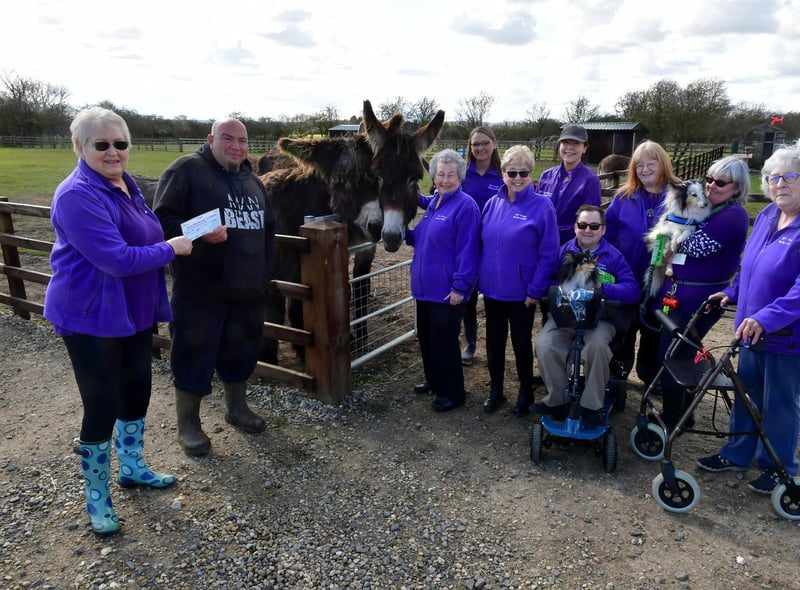 Members of the 50+ Fitness group from Mablethorpe present a cheque to Radcliffe Donkey Sanctuary volunteer Ross Ckarke.