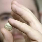 The auction room's David Phillips examines the 2,000 year old gold quarter stater found at Swinhope EMN-220419-151632001