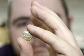 The auction room's David Phillips examines the 2,000 year old gold quarter stater found at Swinhope EMN-220419-151632001