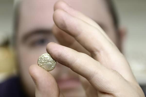 The auction room's David Phillips examines the 2,000 year old gold quarter stater found at Swinhope EMN-220419-151632001