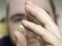 The auction room's David Phillips examines the 2,000 year old gold quarter stater found at Swinhope EMN-220419-151632001
