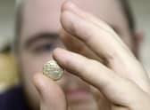 The auction room's David Phillips examines the 2,000 year old gold quarter stater found at Swinhope EMN-220419-151632001