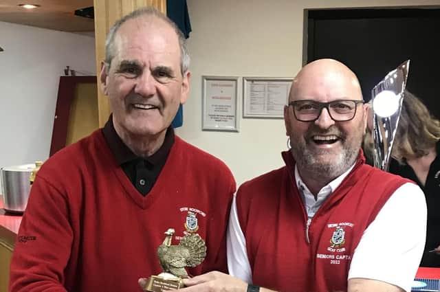 Captain John receives the trophy from Vice-Captain Mike.