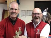 Captain John receives the trophy from Vice-Captain Mike.