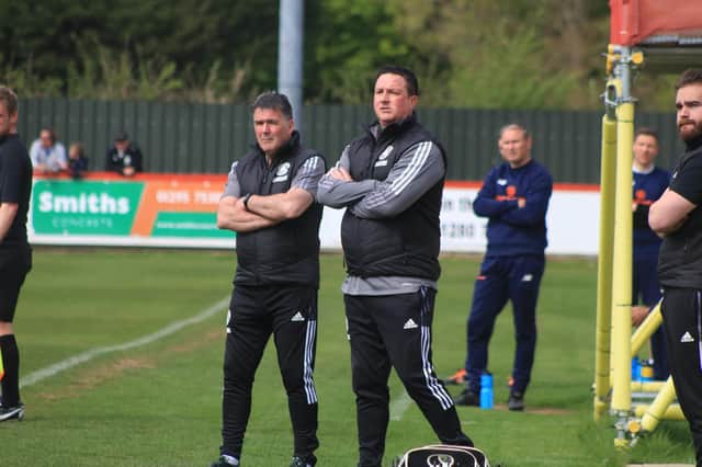 Paul Cox (right) watches over Monday's 1-0 win at Brackley. Photo: Oliver Atkin