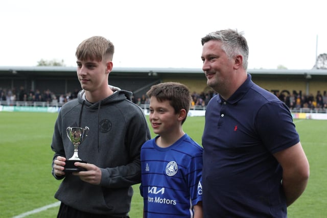 Chris Bray and son Oliver hand the VASS Service Centre U18s Player of the Year award to Finley Rogers. Photo: Oliver Atkin