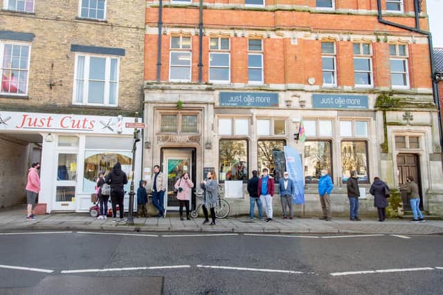 The waiting game: The queue at one of the town’s hair salons on Monday morning.