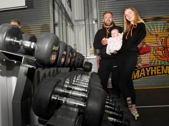 Mayhem Gym owners, Thomas and Sarah Chenery with their 5-month-old daughter, Florence.