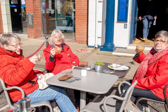 Eating out: Three friends enjoy  the al fresco experieence at the Cornmarket in Louth where businesses have had to turn customers away