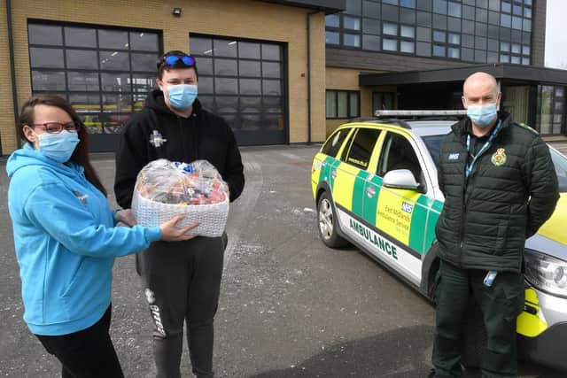 Amanda Taylor and James Maynard of Madmedic Gaming, Sleaford, delivering a hamper to Sleaford Ambulance Station. Receiving the hamper is paramedic, Phil Humberstone. EMN-210419-163708001