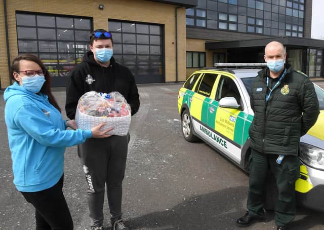 Amanda Taylor and James Maynard of Madmedic Gaming, Sleaford, delivering a hamper to Sleaford Ambulance Station. Receiving the hamper is paramedic, Phil Humberstone. EMN-210419-163708001