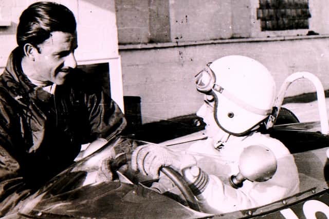 Formula 1 world champion Graham Hill shares a few racing tips at the Folkingham test site back in the sixties. EMN-210416-151006001