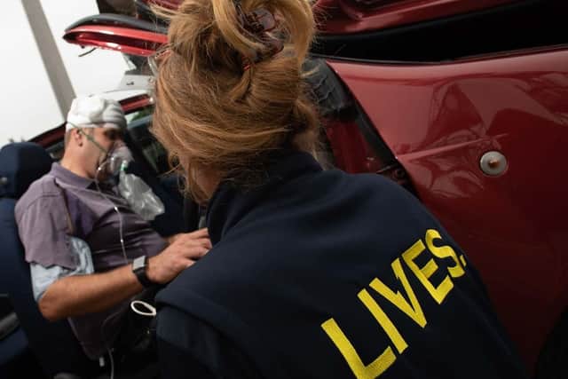 A LIVES responder supports a patient