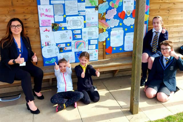 Headteacher Lisa Gleed-Thornley and pupils beside the mural.