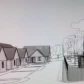 An architect’s drawing of what the main acess road to the care home could look like featuring cottages and the main facility itself.