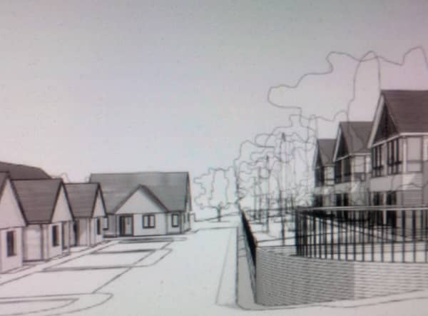 An architect’s drawing of what the main acess road to the care home could look like featuring cottages and the main facility itself.