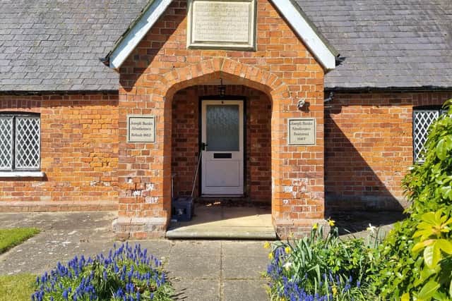 Original plaques above the entrance tell the history of the Almshouses on the Revesby Estate.