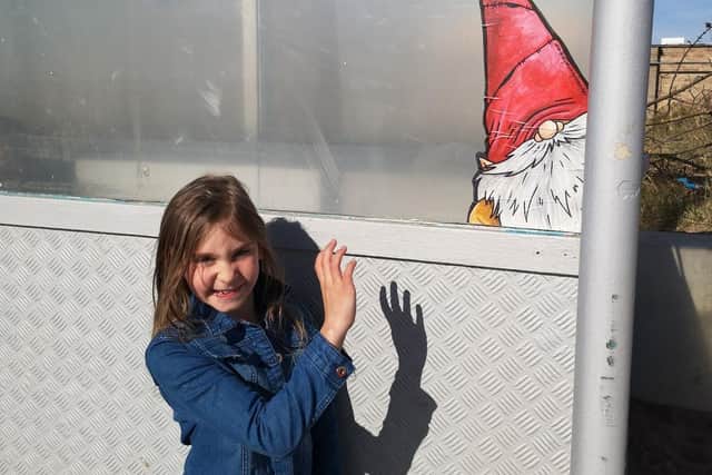 Hello there - this gnome is peeking out of a shelter but Darcey spots him.