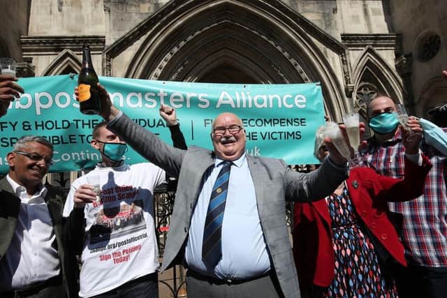 Tom Hedges celebrating with a bottle of Prosecco outside the Royal Courts of Justice in London.