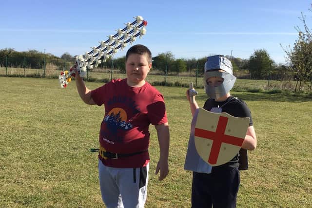 Freddie dressed as St George, and Leon the knight with his homemade sword – made from K'Nex.