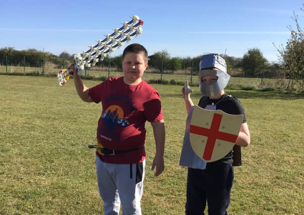 Freddie dressed as St George, and Leon the knight with his homemade sword – made from K'Nex.