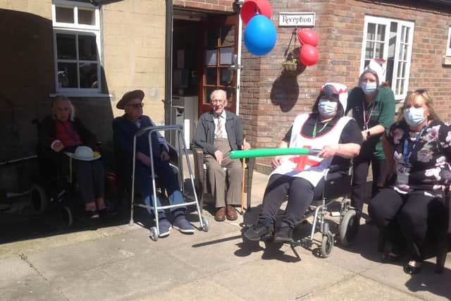 Ready for jousting. Staff and residents at Folkingham's Five Bells care home. EMN-210427-164256001