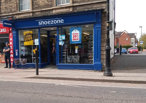 Closing down signs across the windows of the Sleaford branch of Shoe Zone. EMN-210428-164411001