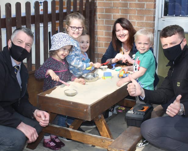Lindum Group managers and Heckington Pre-School Manager Sue Berry see children enjoying their new sandpit. EMN-210505-173501001